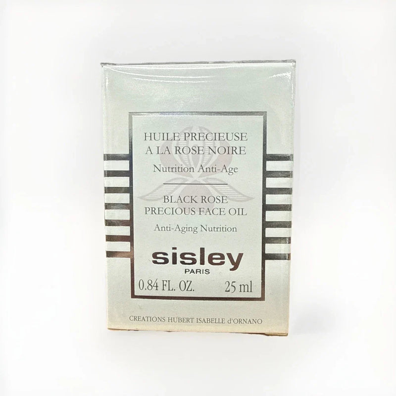 Sisley Black Rose Precious Face Oil bottle with black and gold packaging, 0.84 oz/25ml, displayed on a neutral background.