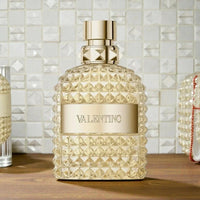 Valentino Uomo Born In Roma The Gold Eau de Toilette for men in a 3.4 oz bottle, sealed, with elegant gold packaging.